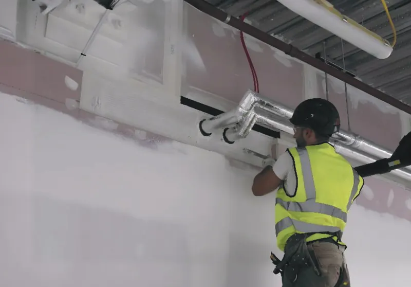 Fire stopping around services above a ceiling
